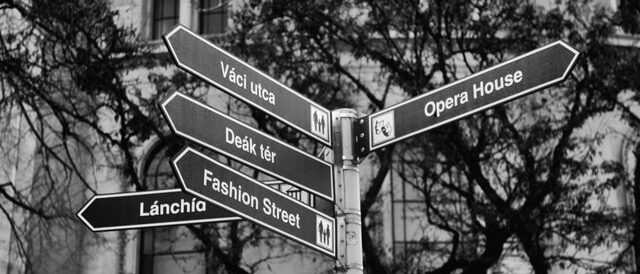 Street signs pointing in a variety of directions