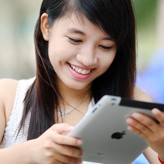 smiling woman using tablet